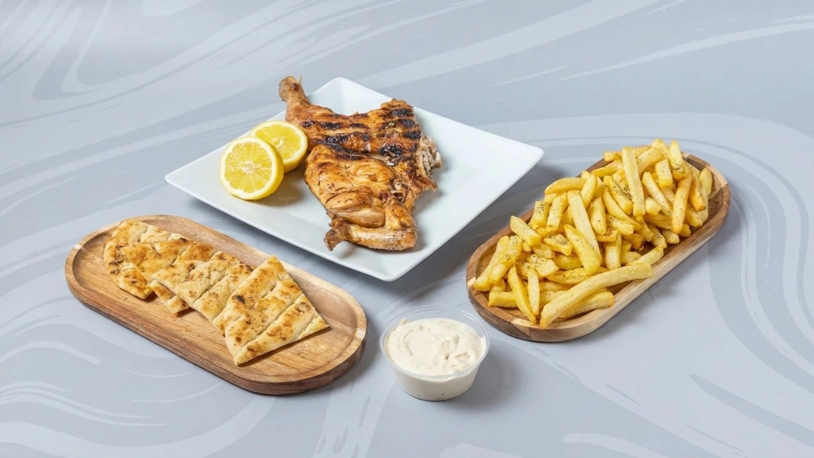 Half a lemon-roasted chicken with a side of French fries, 1 Petros dip sauce, and 2 pita breads